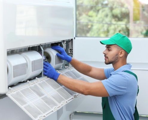 Professional technician maintaining outdoor air conditioner
