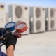 Back view of an HVAC repairman holding a pressure gauge