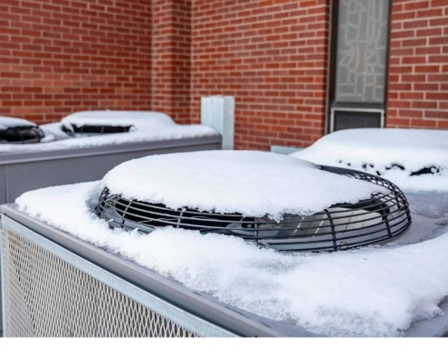 Close up of snow on top of an HVAC unit