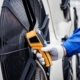 Technician uses a thermal imaging infrared thermometer to check the condensing unit heat exchanger
