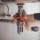 Plumber at work in a bathroom, plumbing repair service