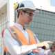 engineer using tablet computer at rooftop building construction or working checking HVAC