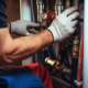 Plumber conducts an inspection and repairs the central heating system