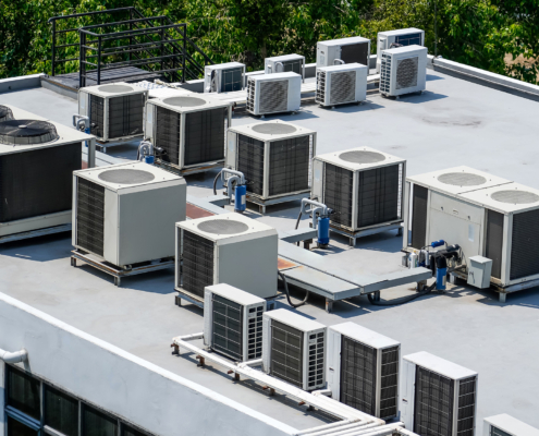 The external units of the commercial air conditioning and ventilation systems are installed on the roof of an industrial building